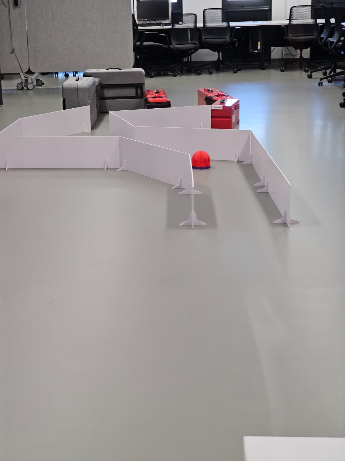 The physical test maze built from reconfigurable white wall panels in the robotics lab